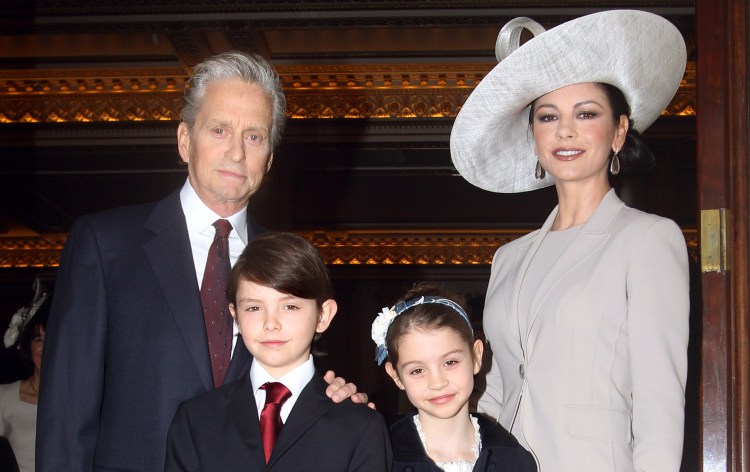 LONDON - FEBRUARY 24: Actress Catherine Zeta-Jones (R) arrives with her husband, actor Michael Douglas and their children Dylan and Carys Douglas, to attend a Royal Investiture at Buckingham Palace on February 24, 2011 in London, England. The 41-year-old Swansea-born actress Catherine Zeta-Jones, who became an Oscar-winning Hollywood star was presented with a CBE by Prince Charles, Prince of Wale in honour of services to the film industry and to charity. (Photo by Lewis Whyld - WPA Pool/Getty Images)